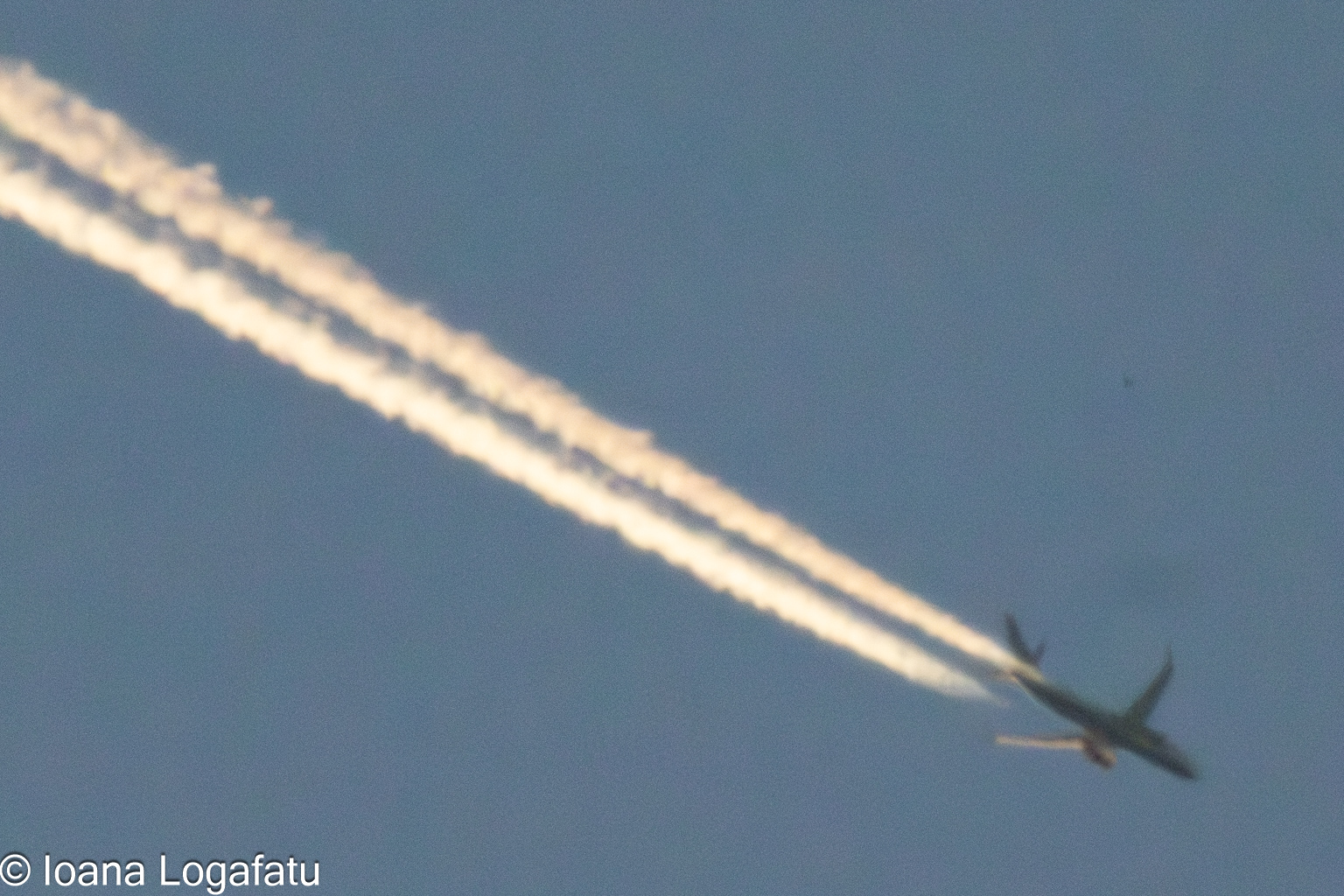 Airplane soaring through a bright blue sky